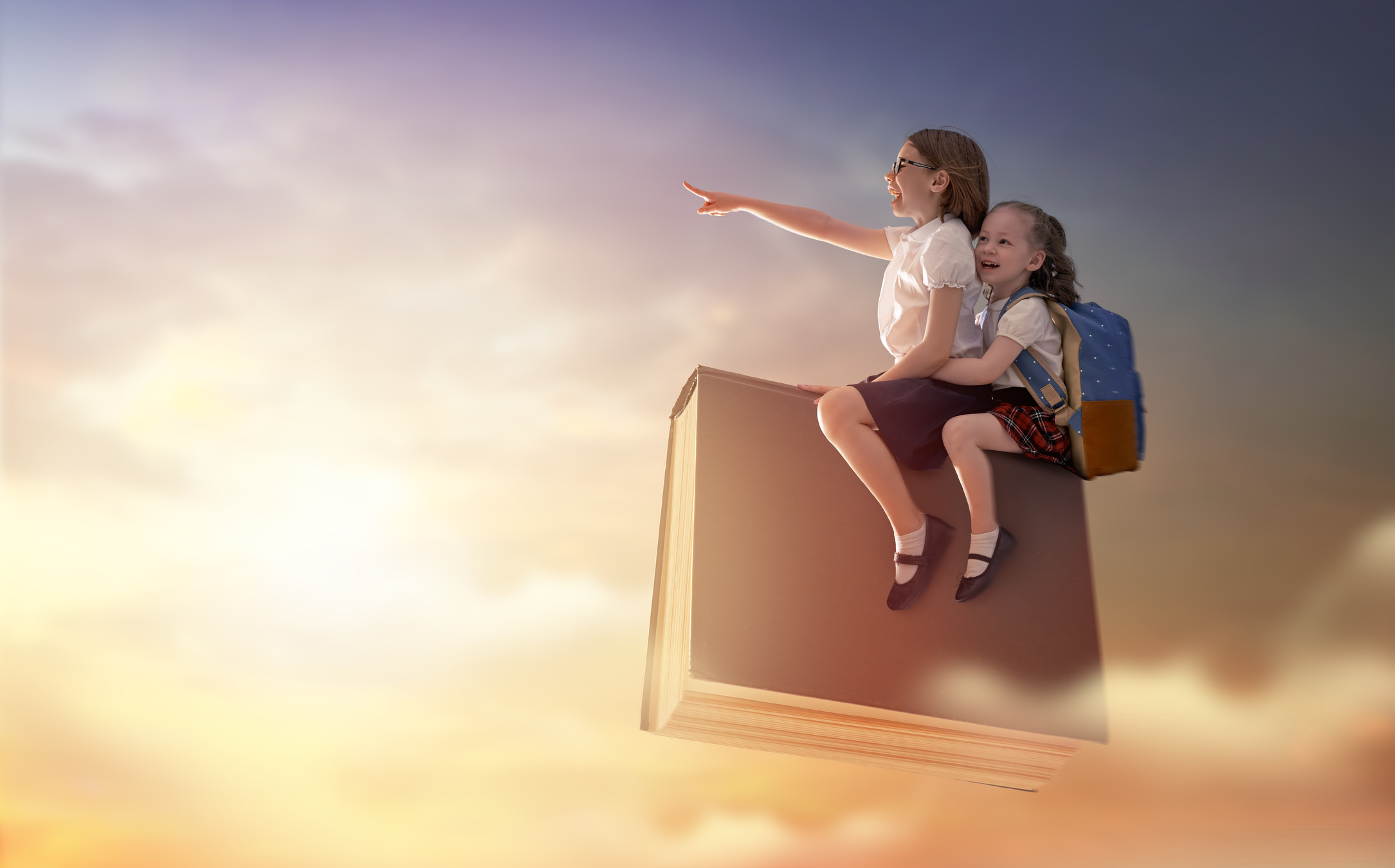 children flying on the book